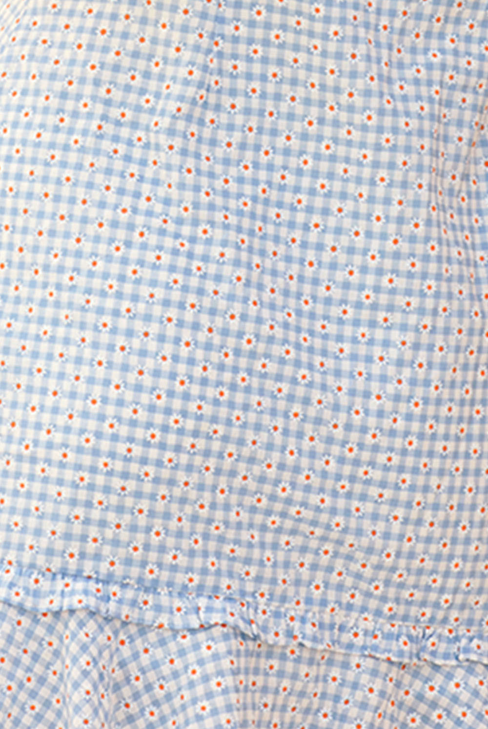 Blue checkered dress with small red and white flower print on a beige background