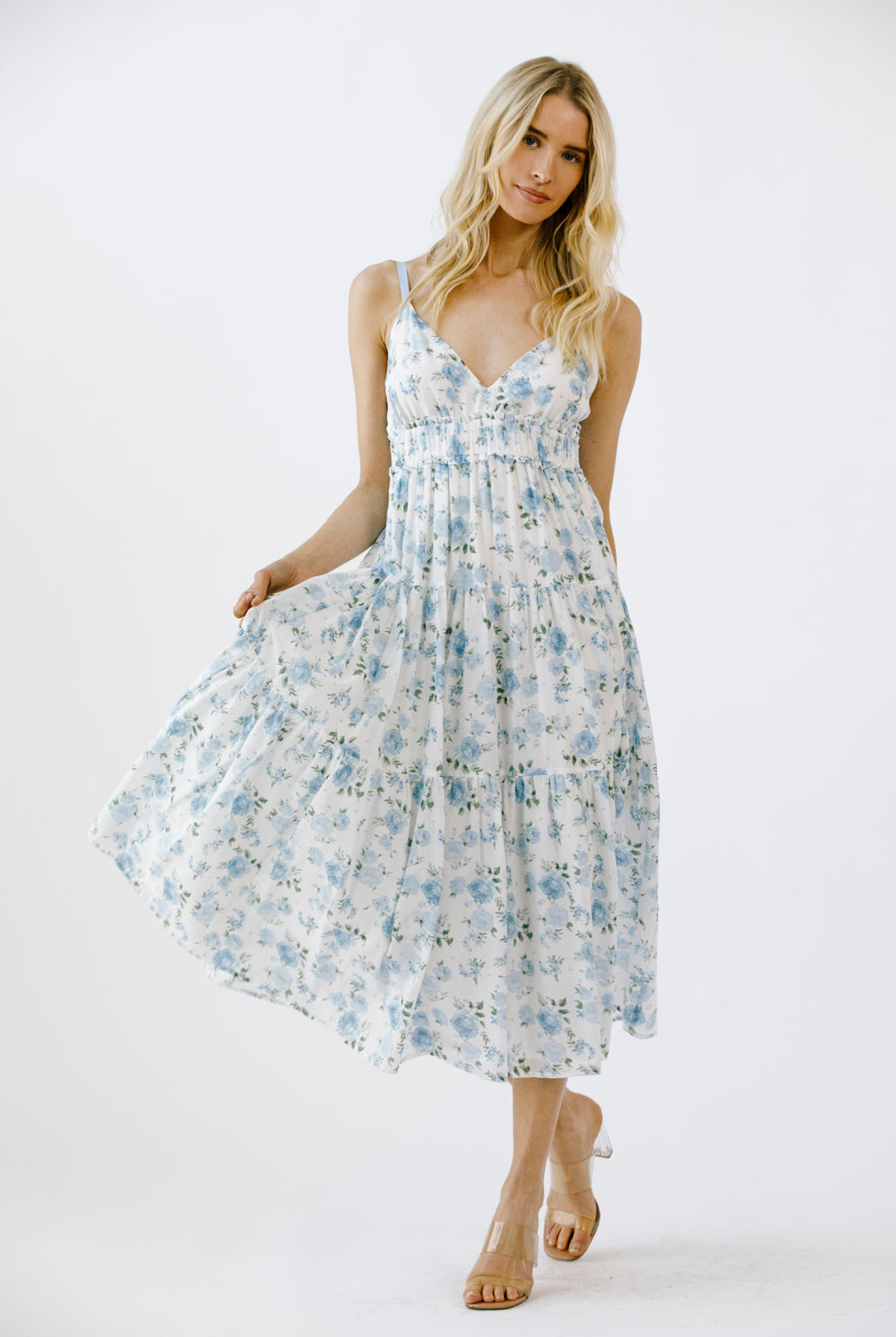 Woman wearing a floral midi dress on a white background