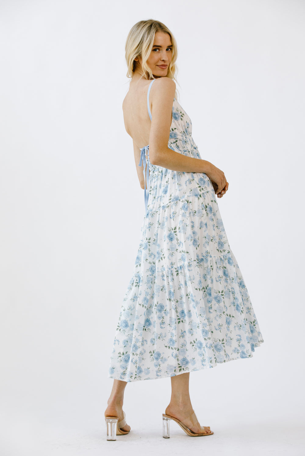 Woman wearing a floral dress on a white background