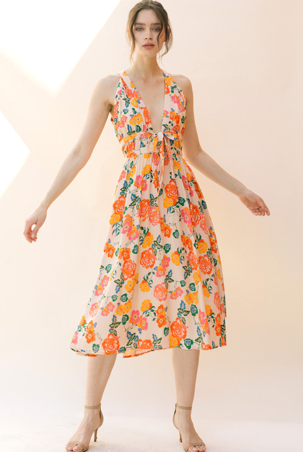 Woman wearing a floral dress on a plain background