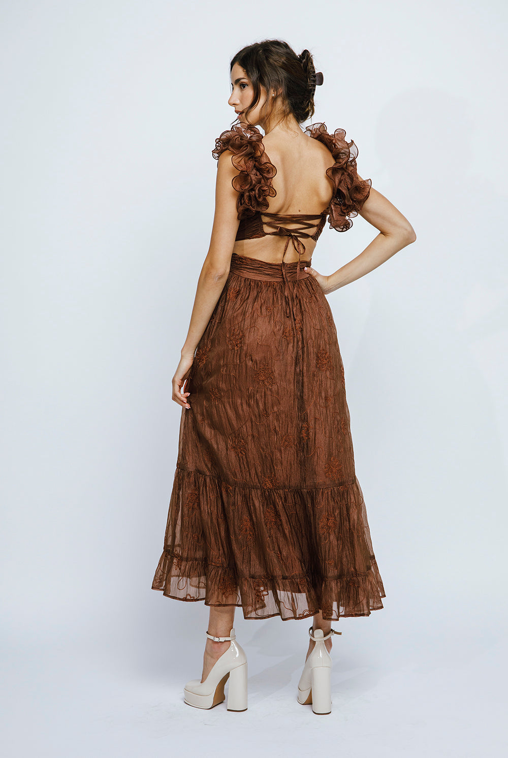 Back view of a brown lace-up maxi dress with ruffled straps