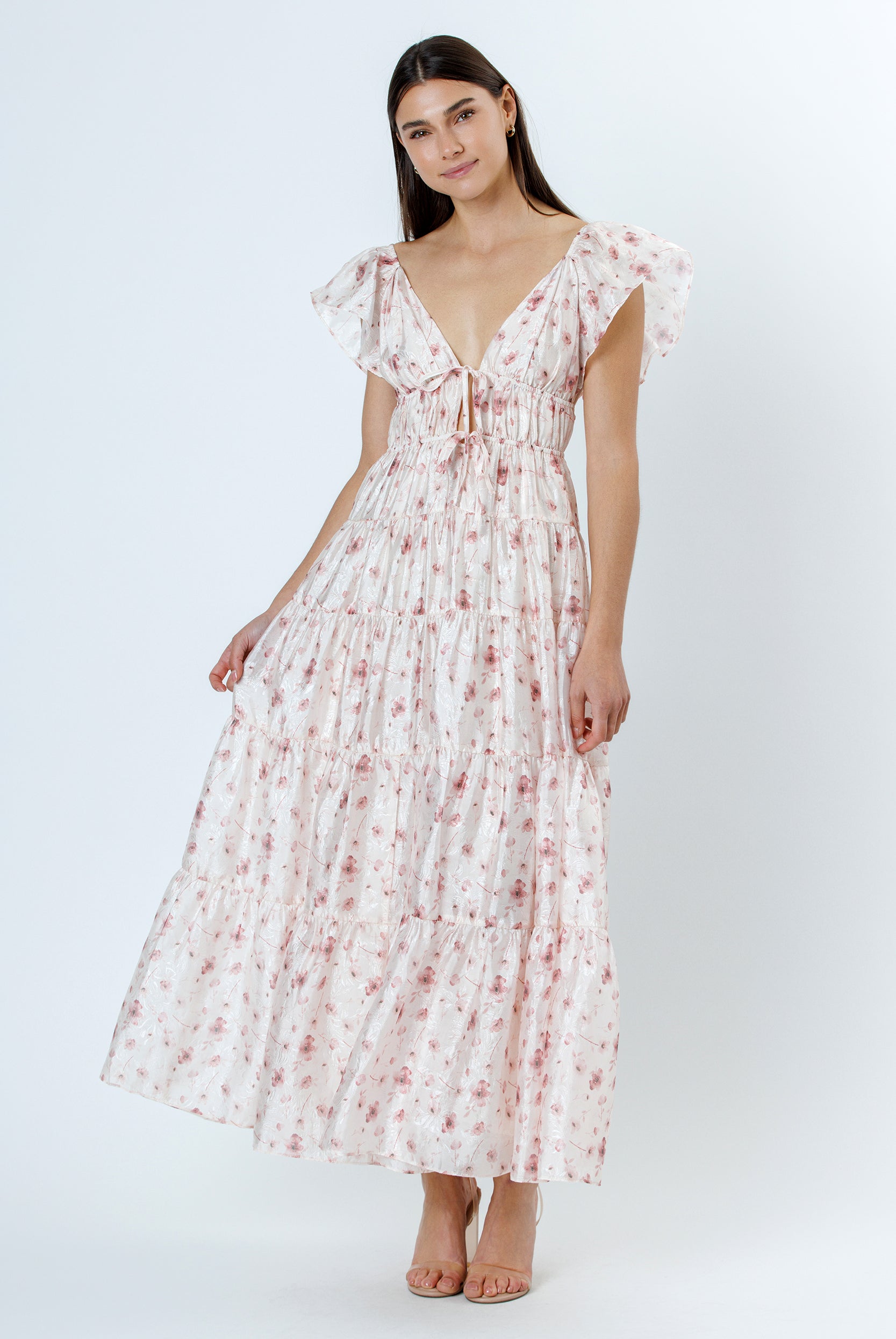 Woman wearing a floral maxi dress on a white background