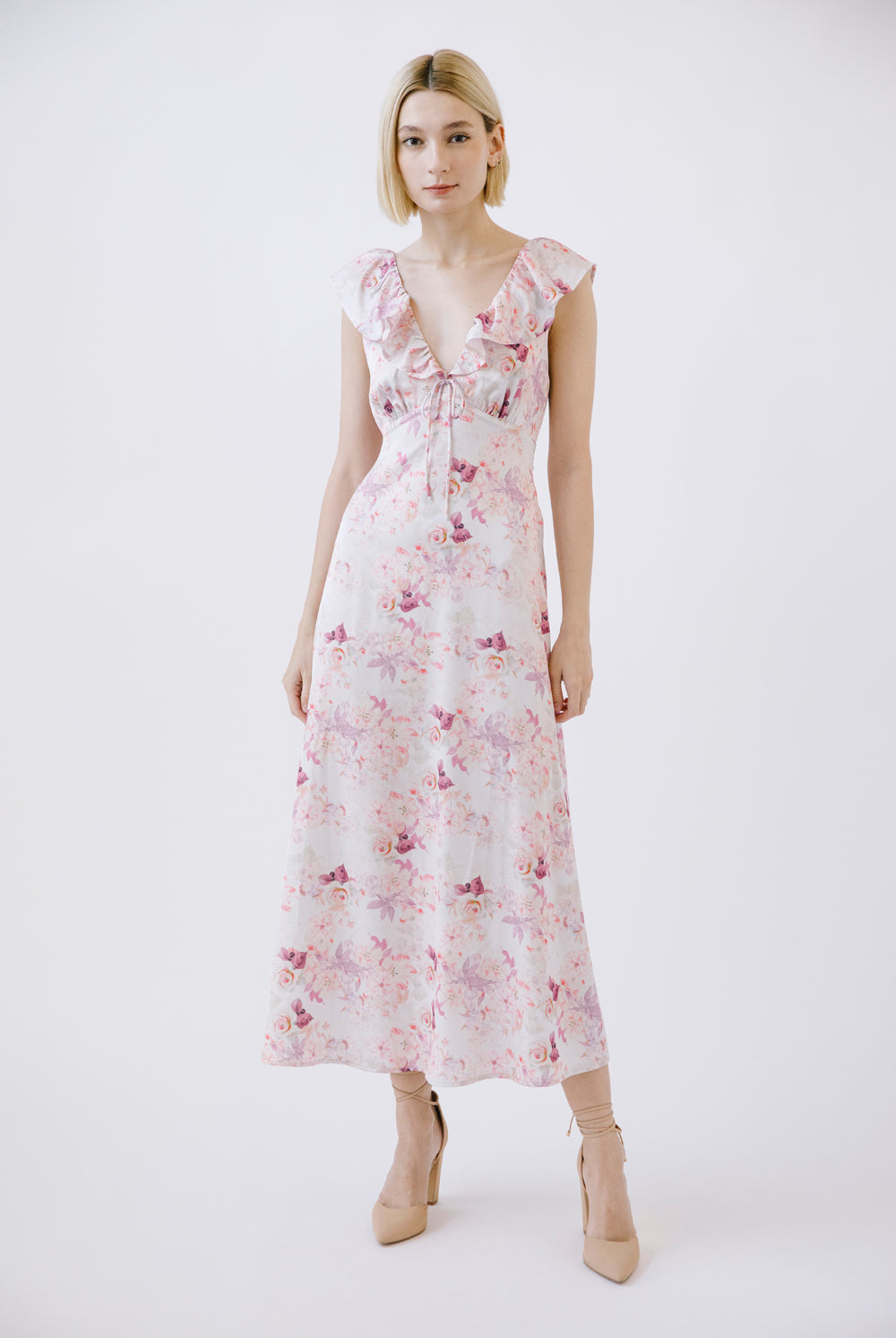 Woman wearing a purple floral dress on a white background