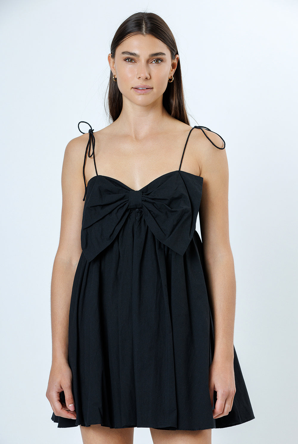 Black dress with bow detail on a white background