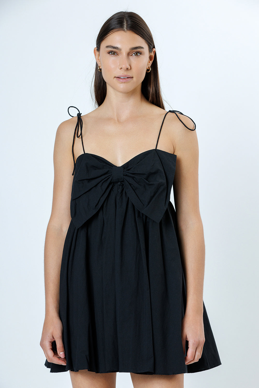Black dress with bow detail on a white background