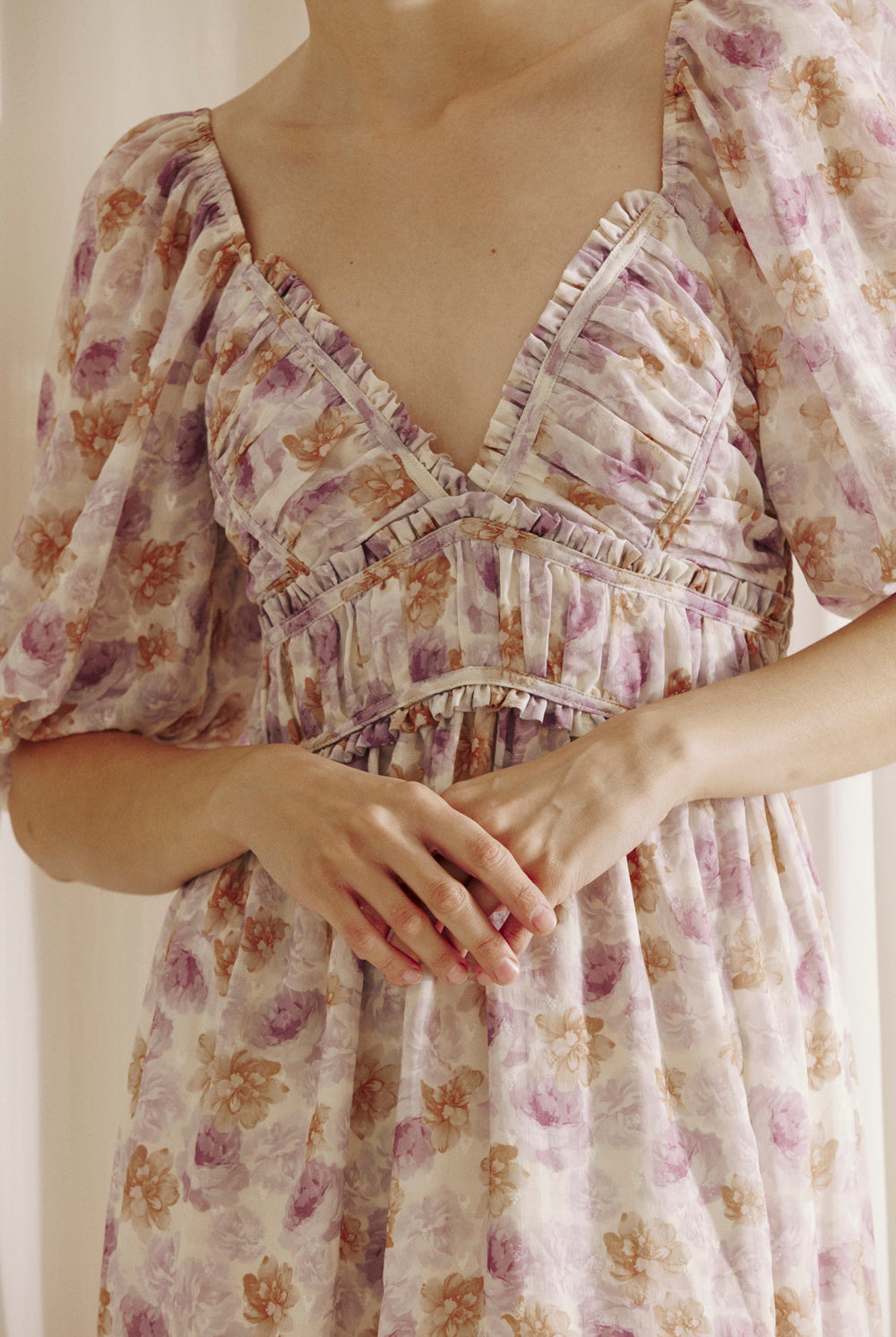 A person wearing a purple floral dress