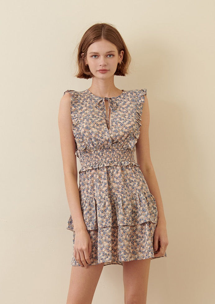 Woman wearing a blue floral dress on a beige background