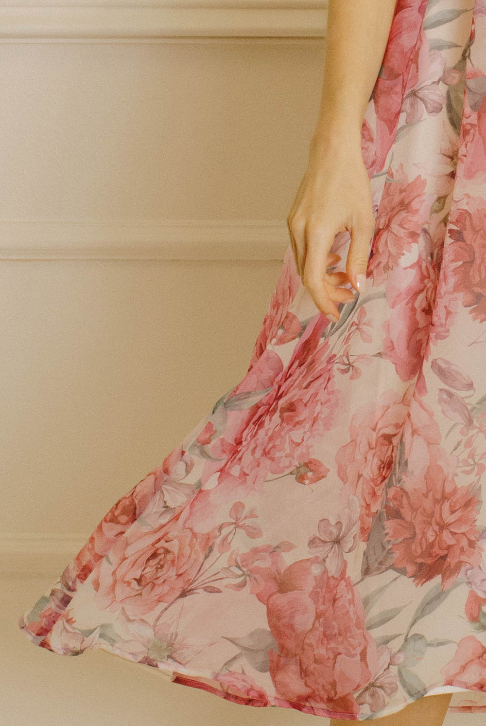Floral print dress against a neutral wall