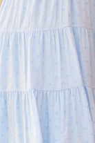 Light blue dress on a beige background