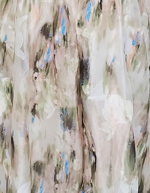 Green and blue tie dye effect dress standing against a plain background