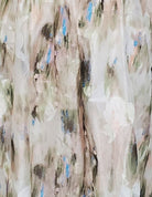 Green and blue tie dye effect dress standing against a plain background