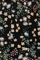 Close-up black dress with floral pattern