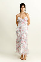Woman wearing a purple floral dress on a white background