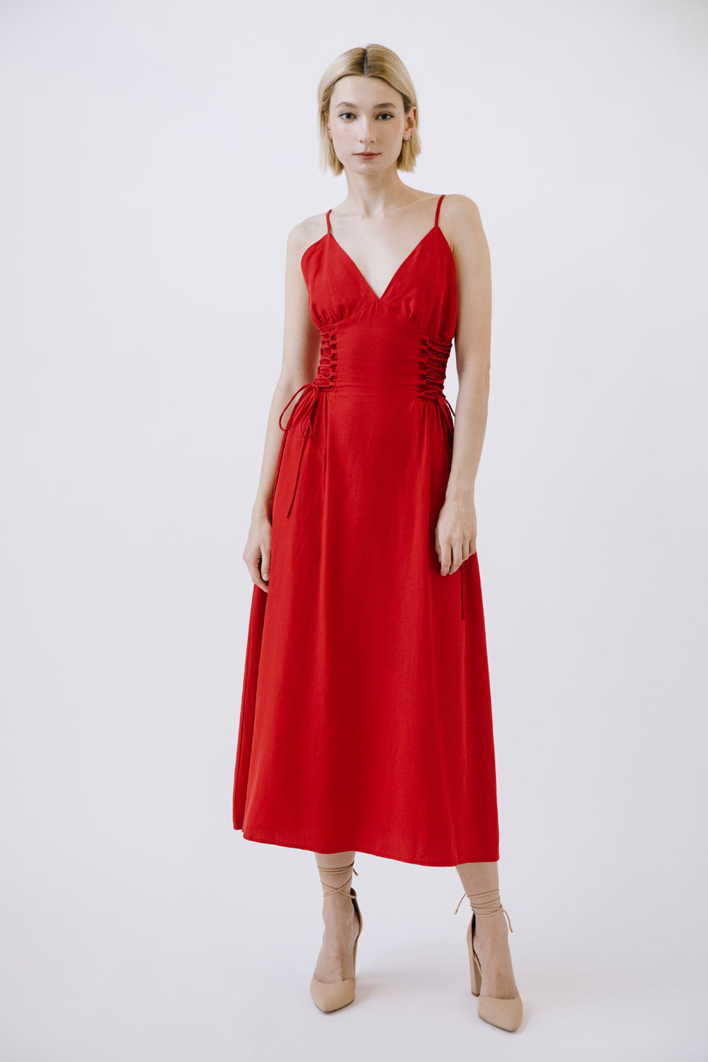 Woman wearing a red midi dress on a white background