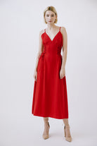 Woman wearing a red midi dress on a white background