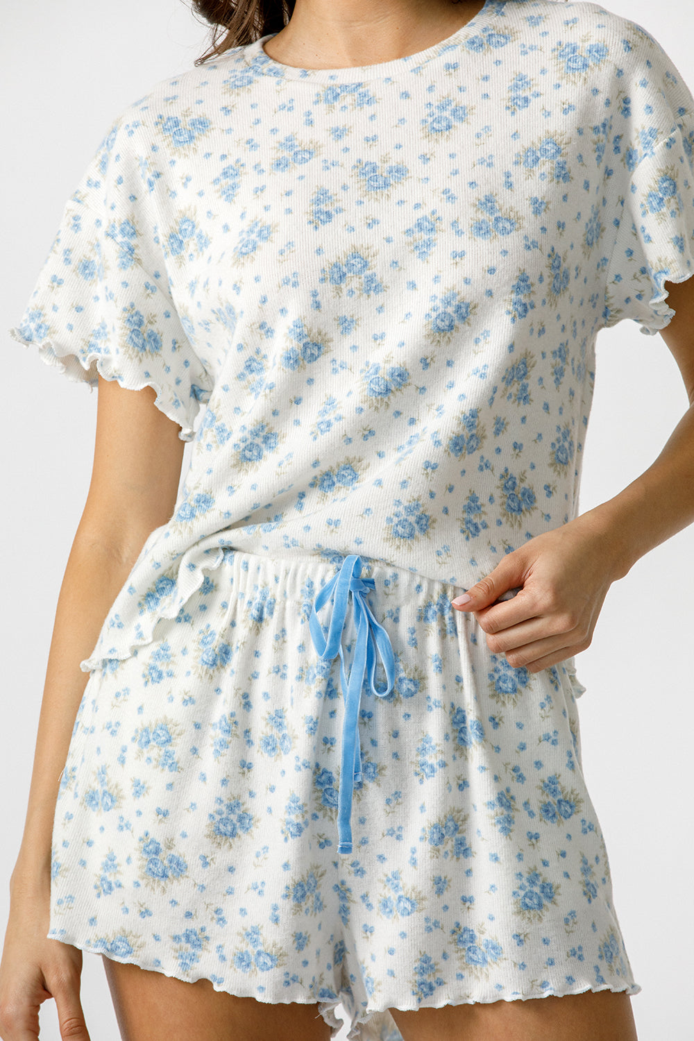 Floral pajama set with a blue drawstring on a plain background