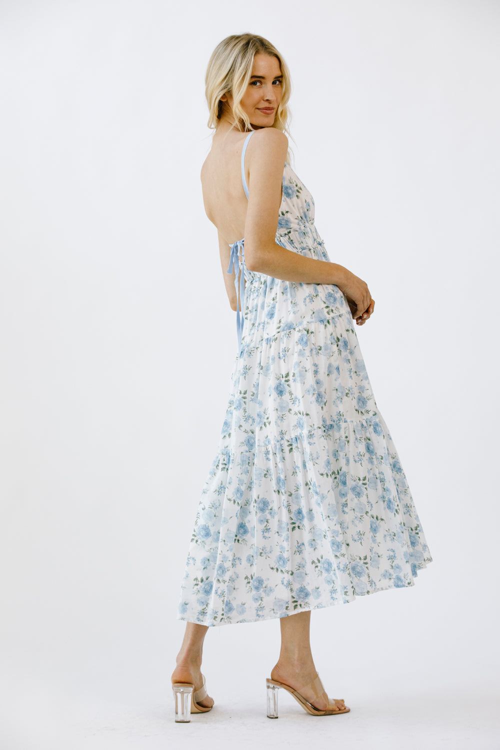 Woman wearing a floral dress on a white background