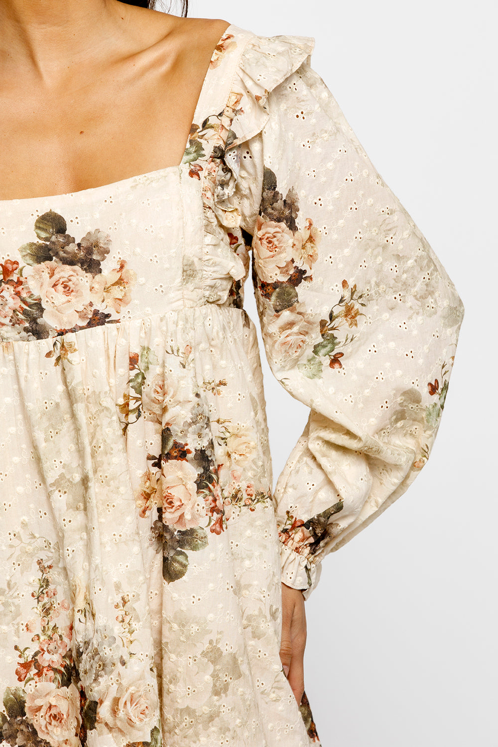 Floral off-shoulder dress with long sleeves on a plain background