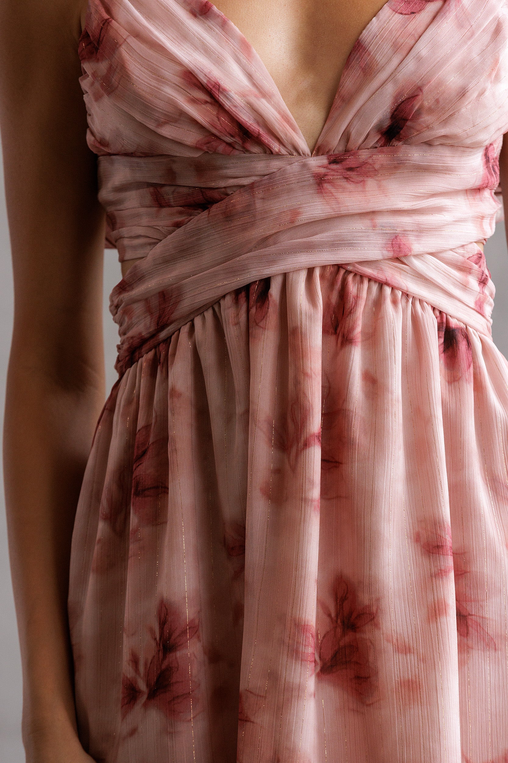 Close-up of a pink floral dress with a plain background