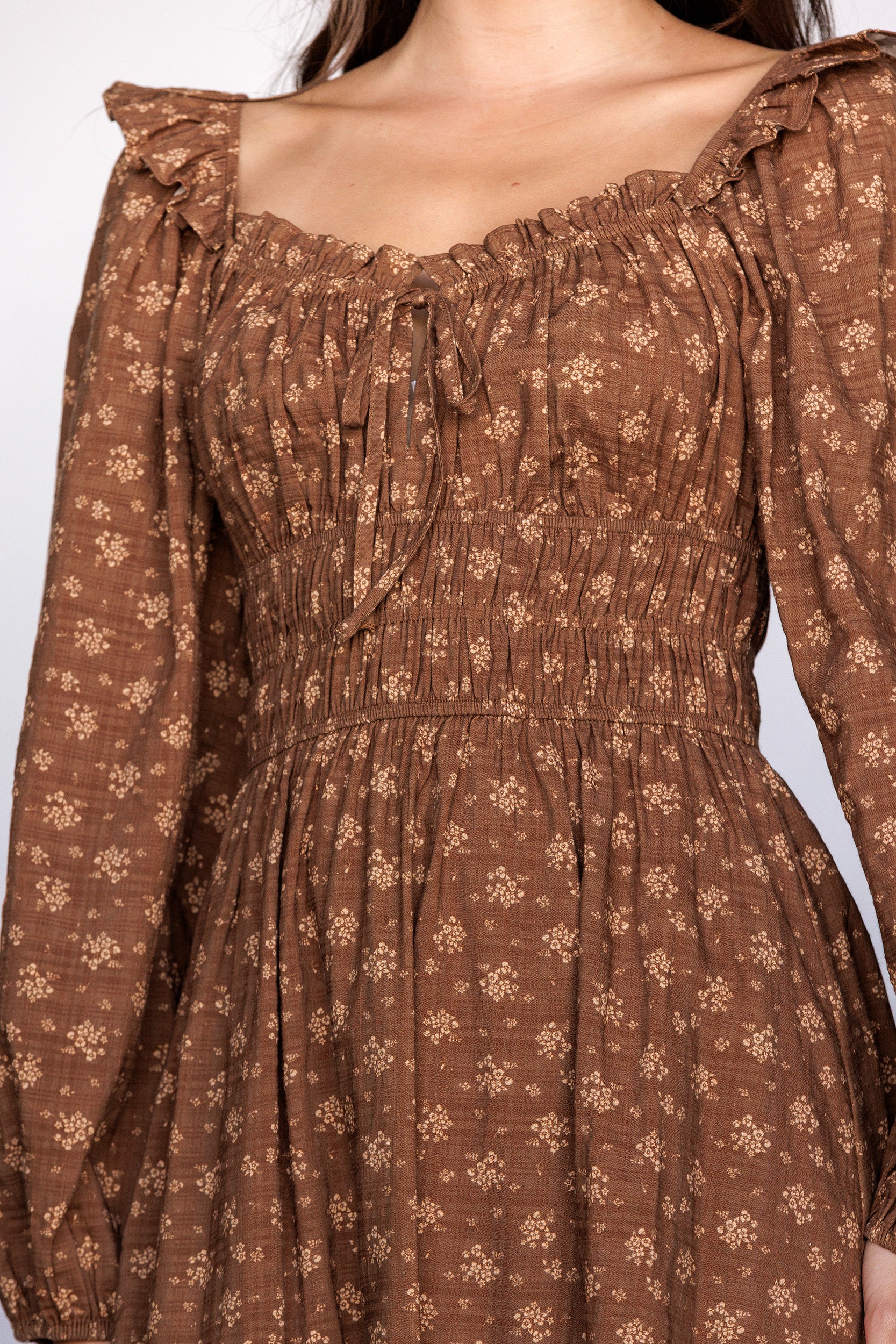 Brown floral dress with long sleeves on a white background