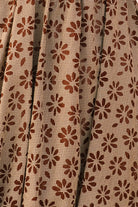 Close-up of fabric with brown gingham with floral embroidery