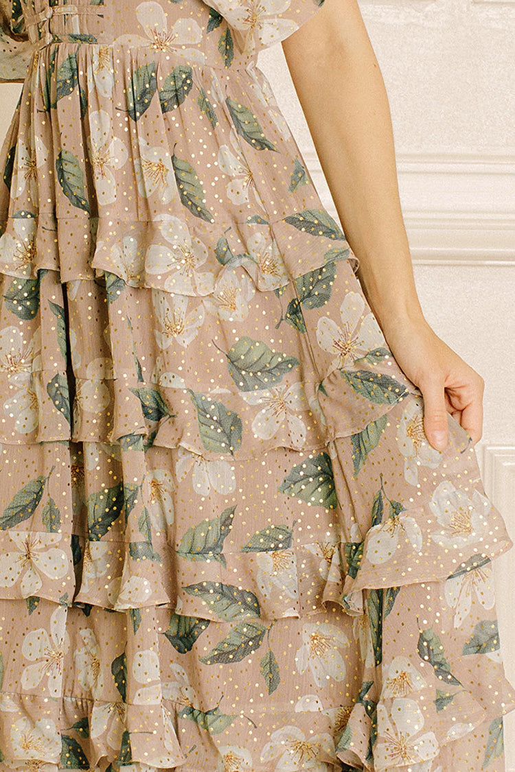 Beige dress with green leaf pattern worn by a person