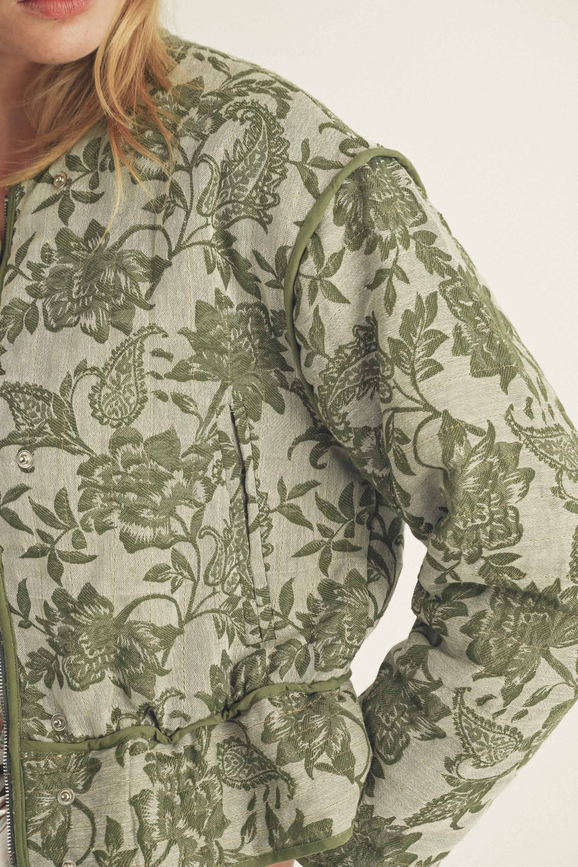 Green floral patterned fabric on a white background