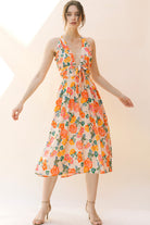 Woman wearing a floral dress on a plain background