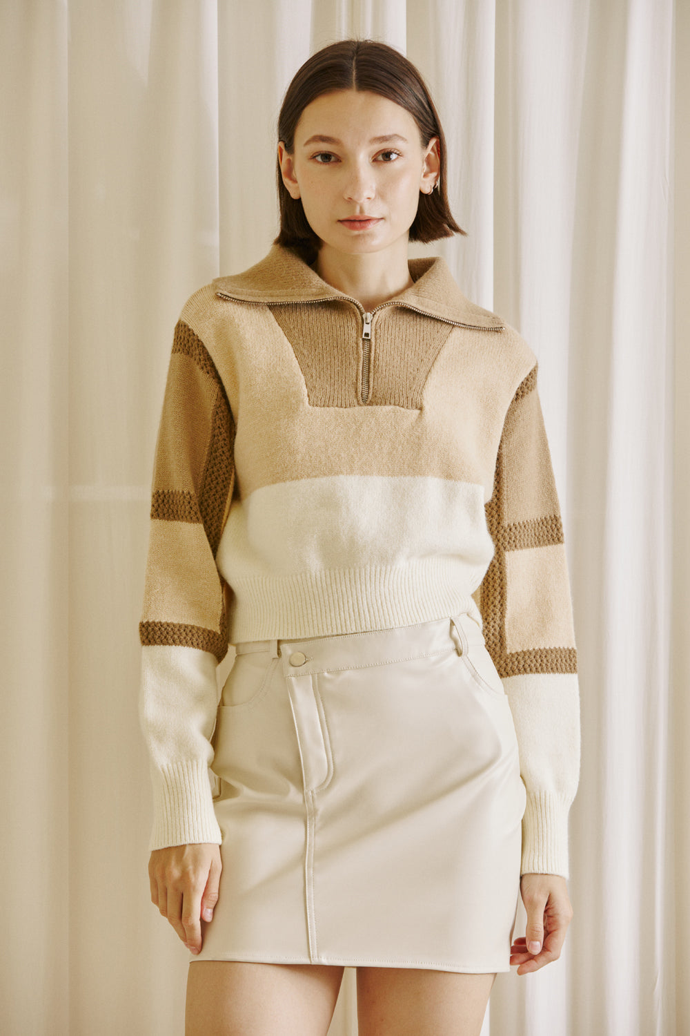  Woman wearing a brown and beige color block sweater