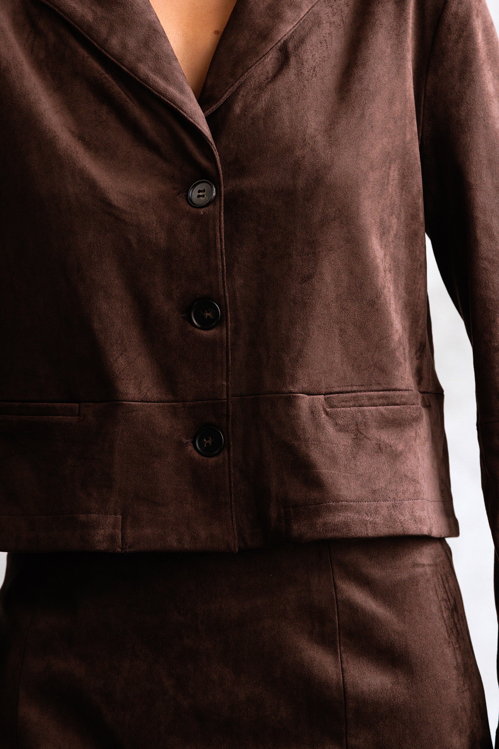 Brown suit jacket with buttons on a white background