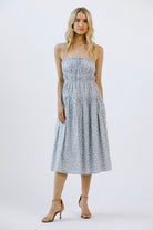 Woman wearing a blue floral dress on a white background