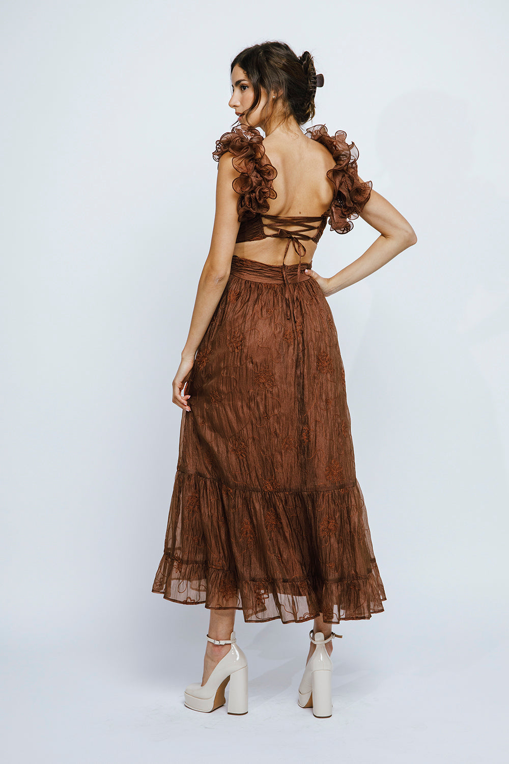 Back view of a brown lace-up maxi dress with ruffled straps