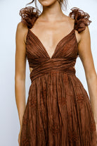 Brown dress with ruffled sleeves on a white background