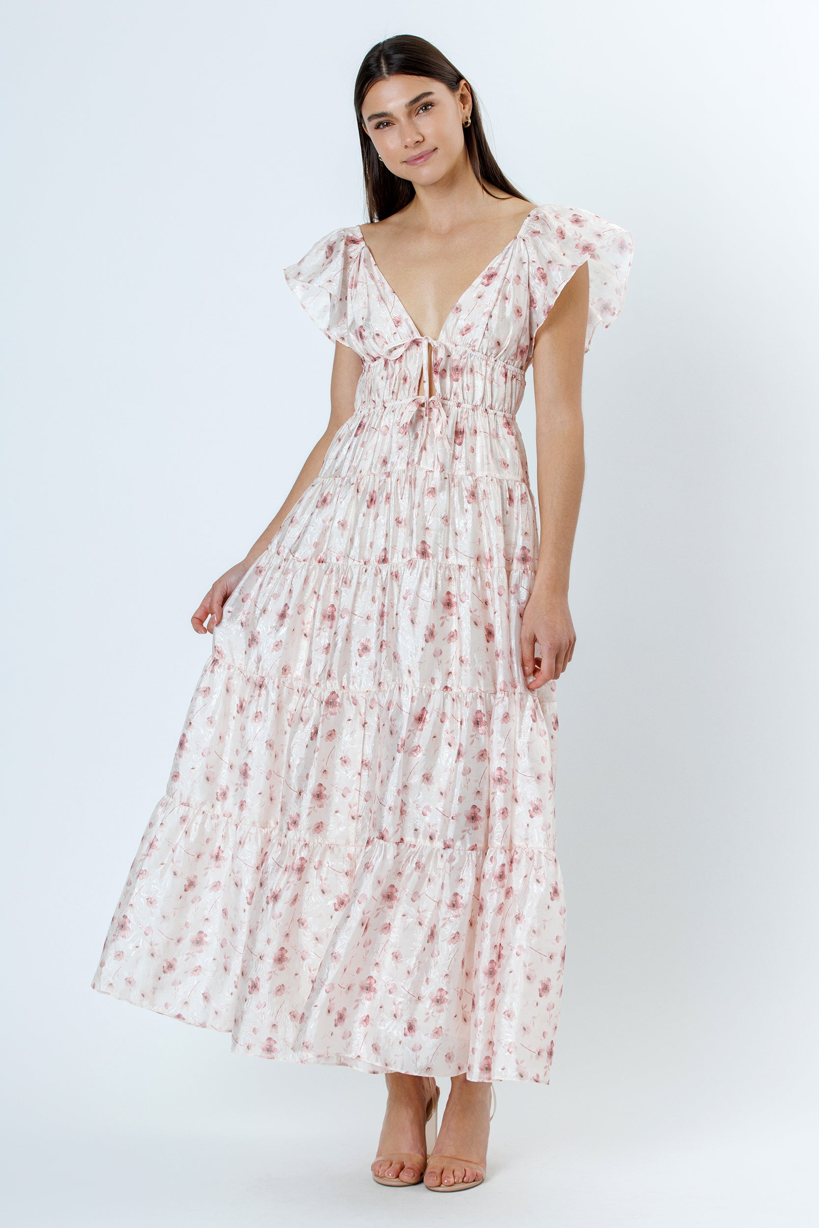 Woman wearing a floral maxi dress on a white background