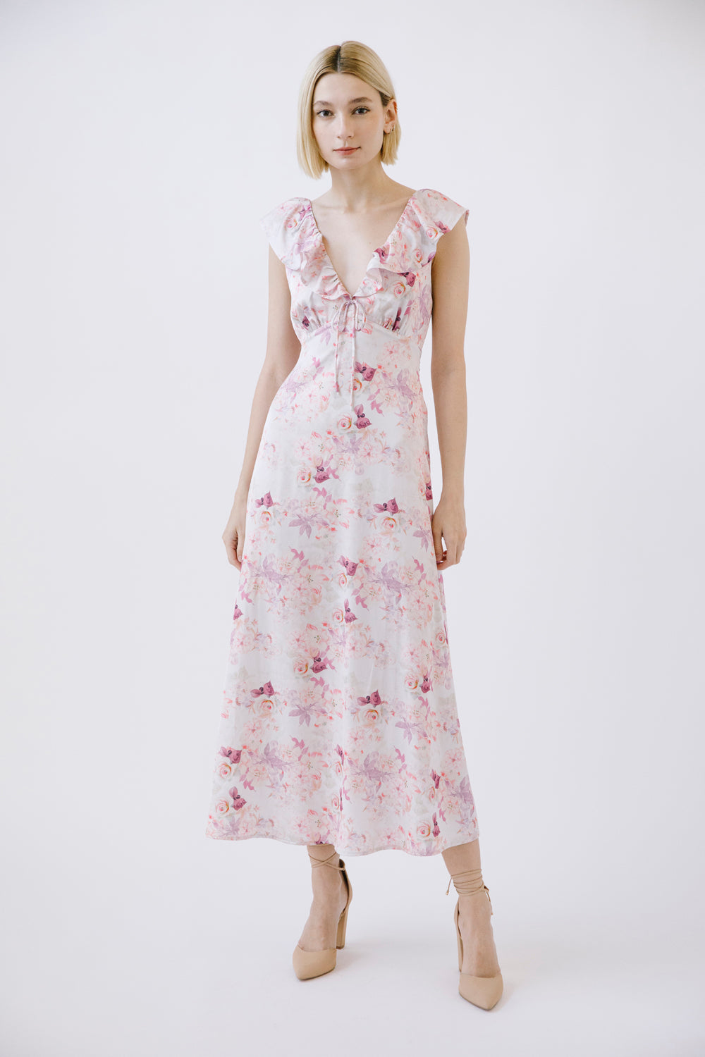 Woman wearing a purple floral dress on a white background