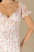 White and pink floral dress with a beige background