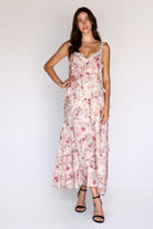 Woman wearing a floral dress against a white background