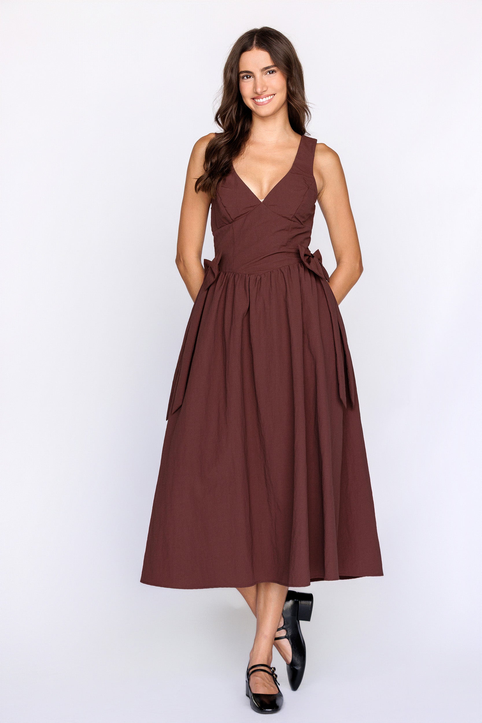 Woman wearing a brown dress on a white background