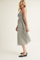 Woman wearing a black checkered dress on a white background