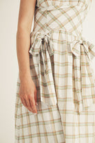 Mint and brown plaid dress with a tie waist on a plain background