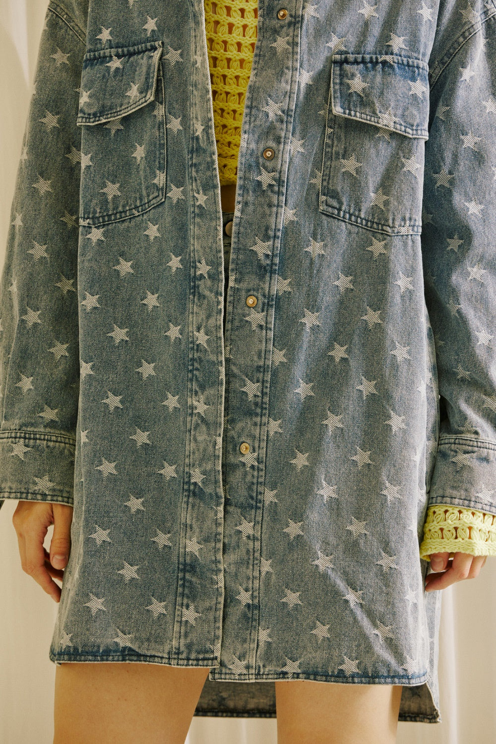 A star-patterned denim jacket against a neutral background
