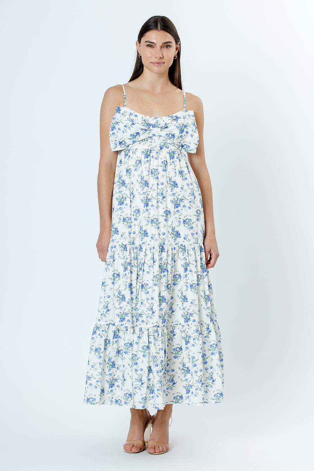 Woman wearing a floral dress with blue flowers on a white background