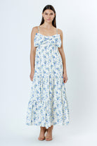 Woman wearing a floral dress with blue flowers on a white background