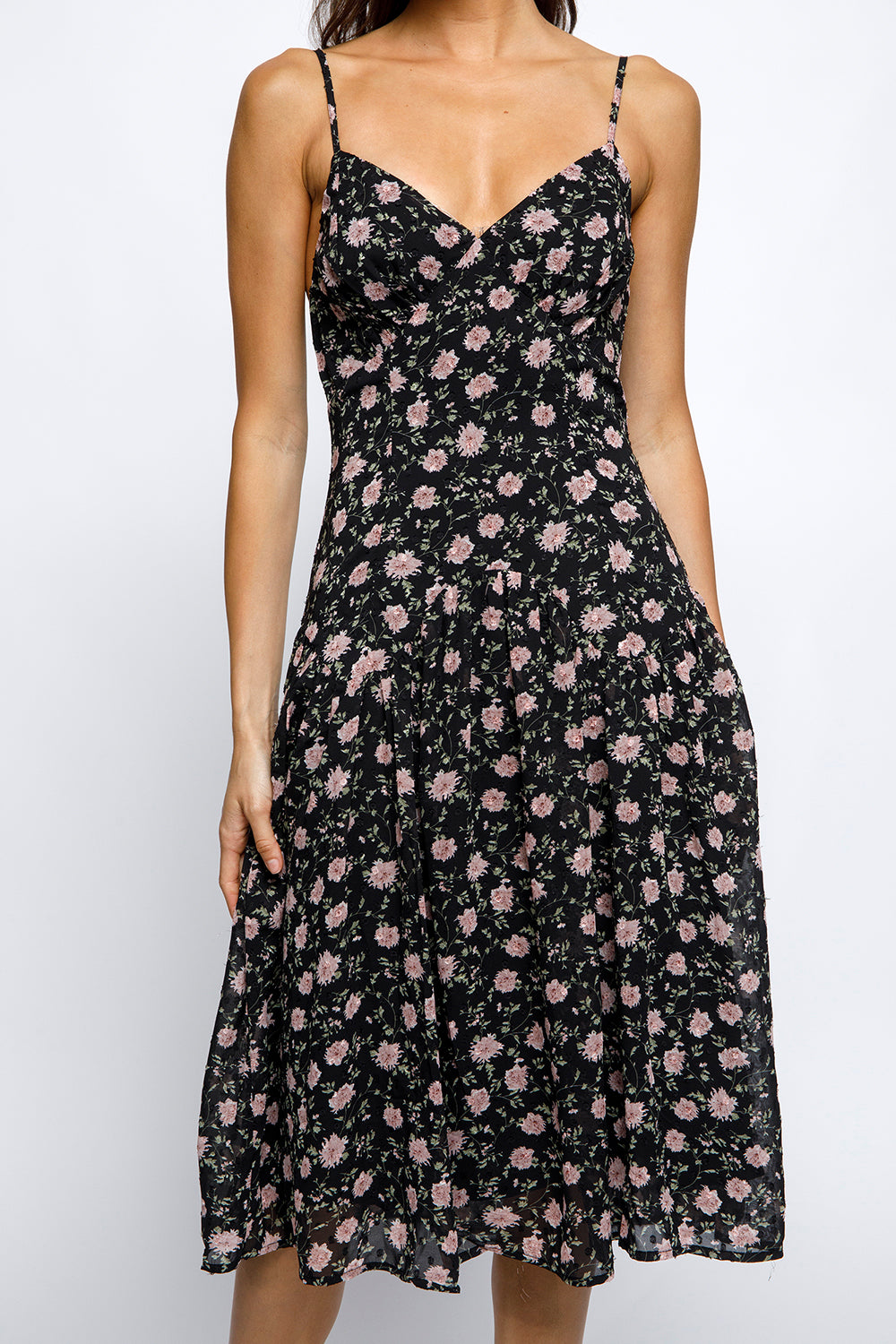 Black floral dress worn by a person on a white background