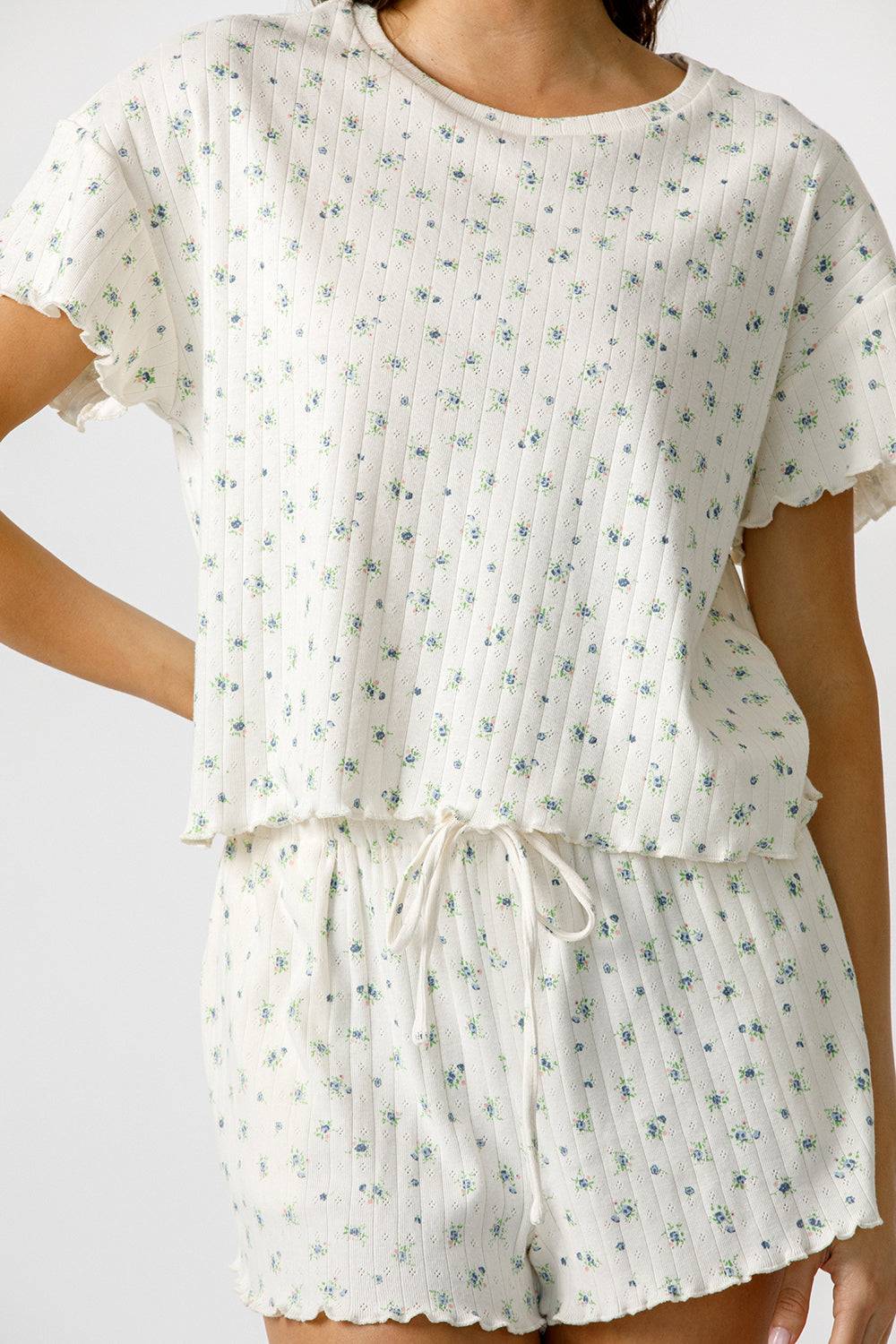Cream pajama set with blue floral pattern on a white background