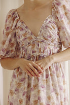 A person wearing a purple floral dress