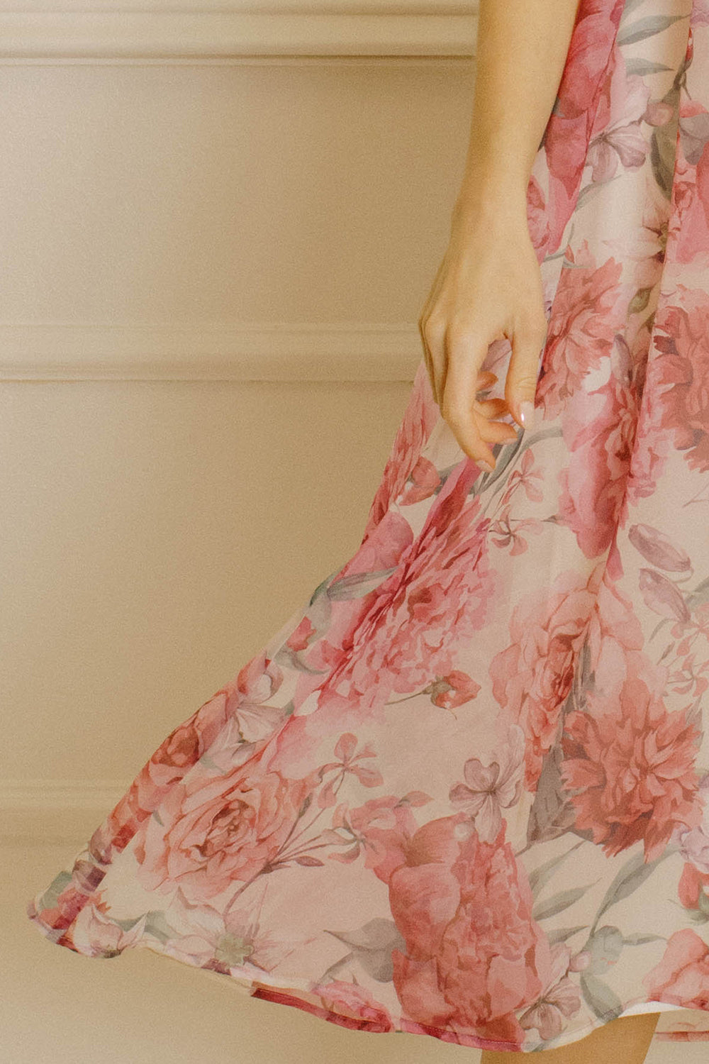 Floral print dress against a neutral wall