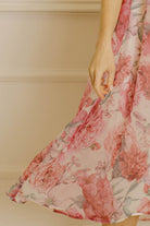Floral print dress against a neutral wall