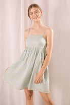 Woman wearing a light blue dress against a plain background