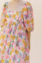 Pink floral midi dress against a plain background